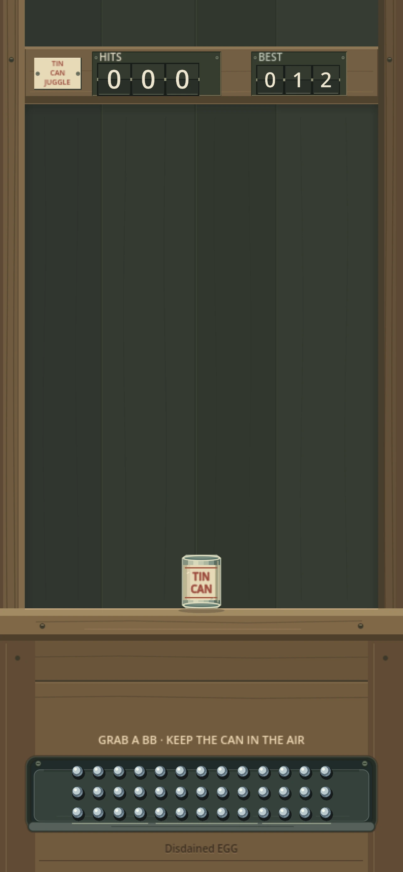 Tin Can Juggle’s wooden cabinet: HITS and BEST counters above a cream-and-red can, with a tray of BBs below the workbench.